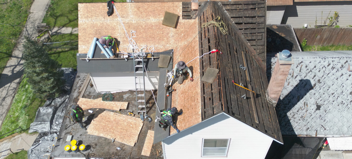 Workers repair the damaged roof of a US veteran
